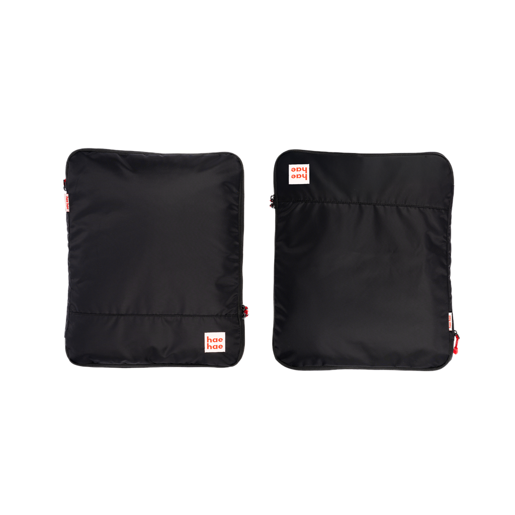 Two black compression packing cubes with a brand logo on a white background
