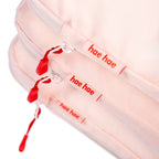 Pink blossom hae hae packing cubes close up of the red detail zips