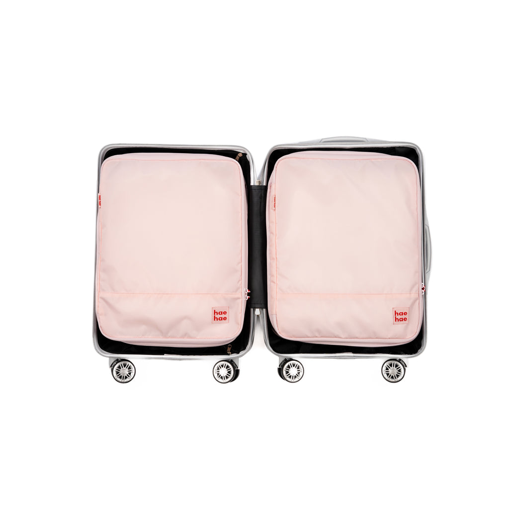 Two hae hae compression packing cubes within a carry on case