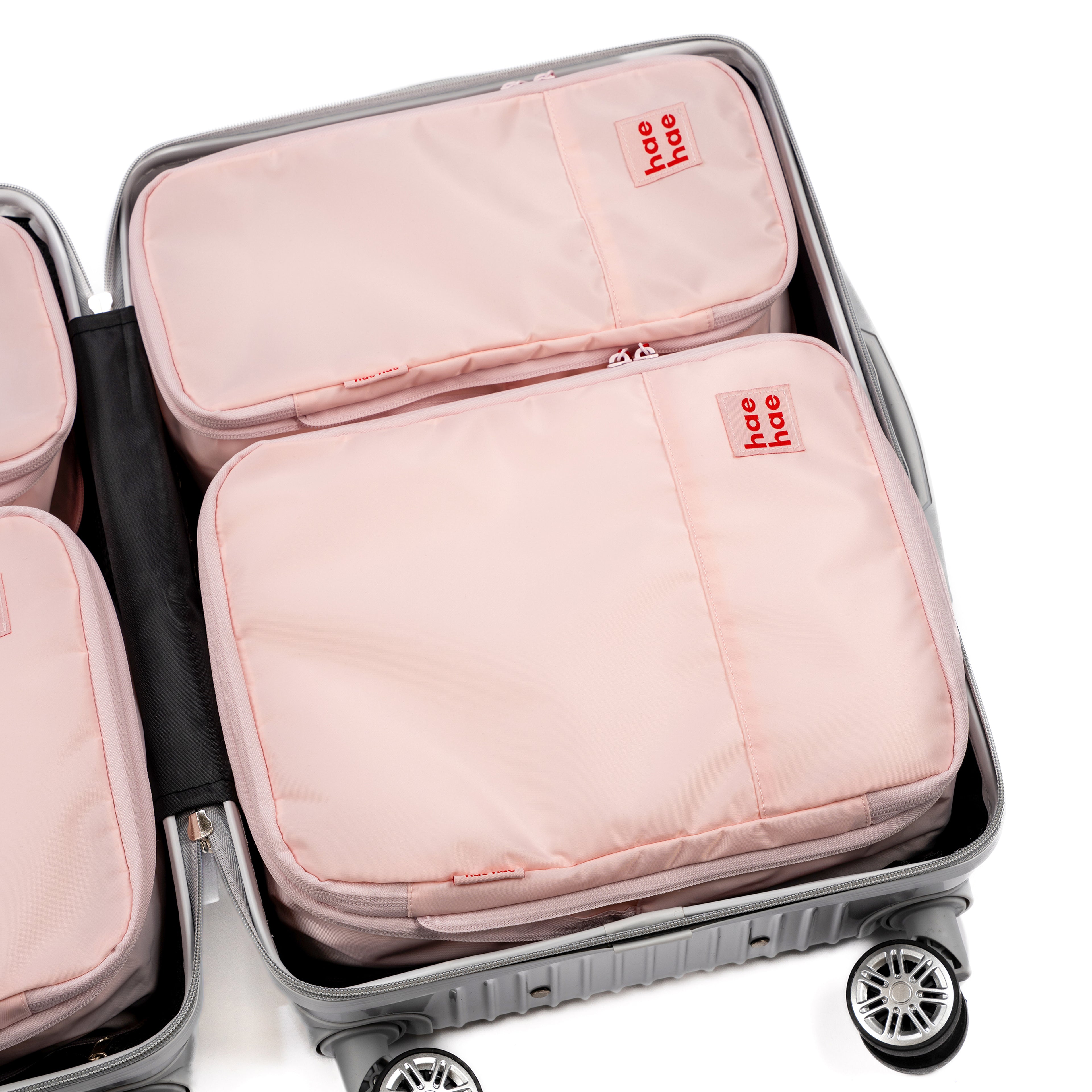 hae hae Blossom compression packing cubes packed inside a cabin suitcase, 4 pack